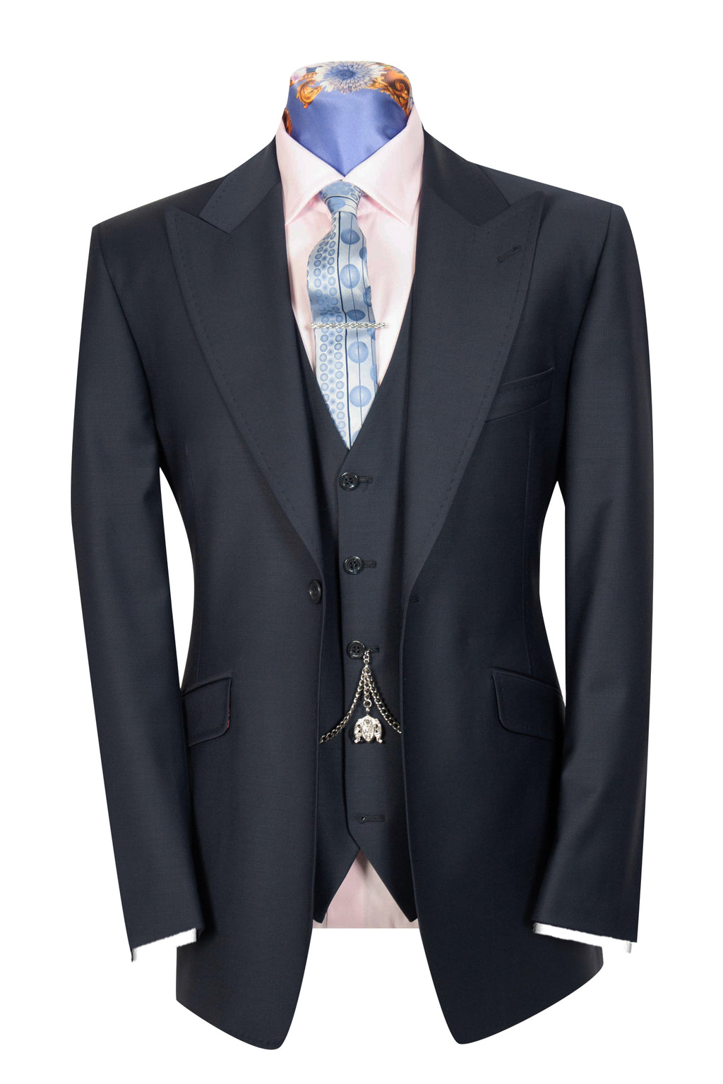 A navy three-piece suit with a peak lapel, double vented back
