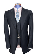 A navy three-piece suit with a peak lapel, double vented back