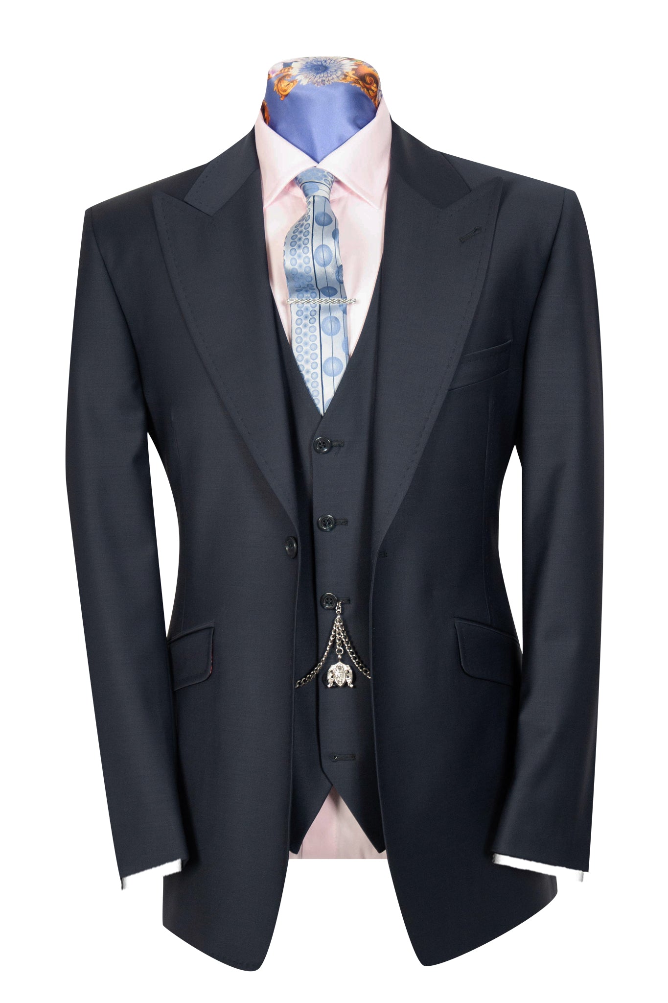 A navy three-piece suit with a peak lapel, double vented back